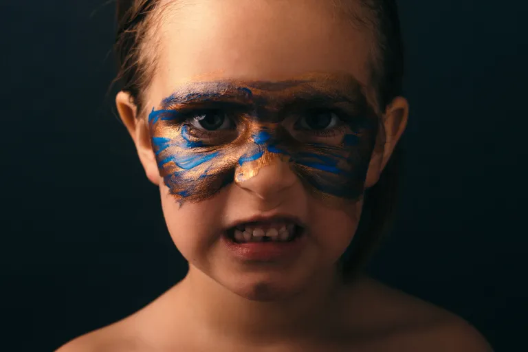 Child reacting with fight, flight or freeze response triggered by shame